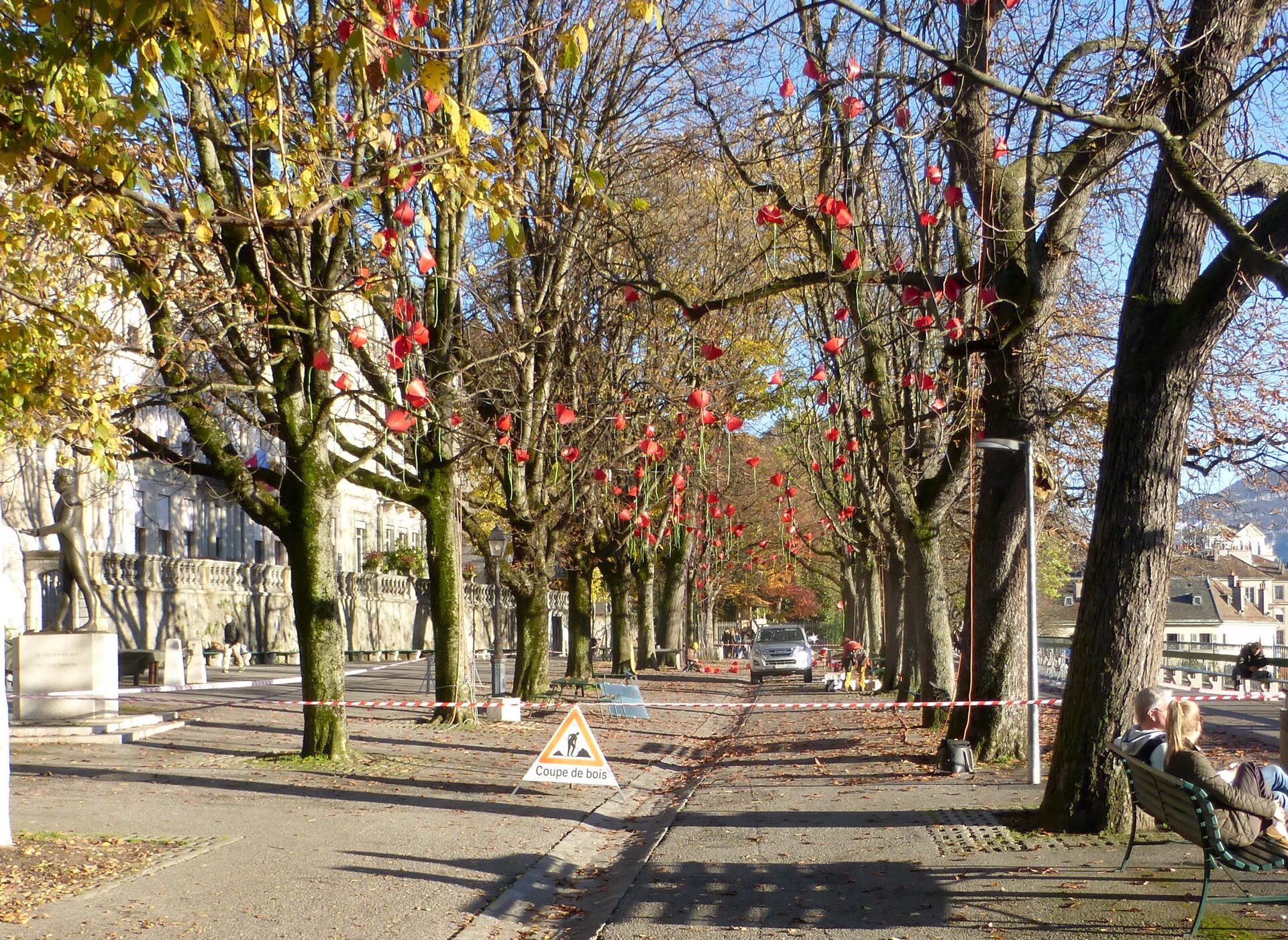 The tree-lined Promenade de la Treille in Geneva's Old Town in early November sunshine, with autumn leaves on the ground