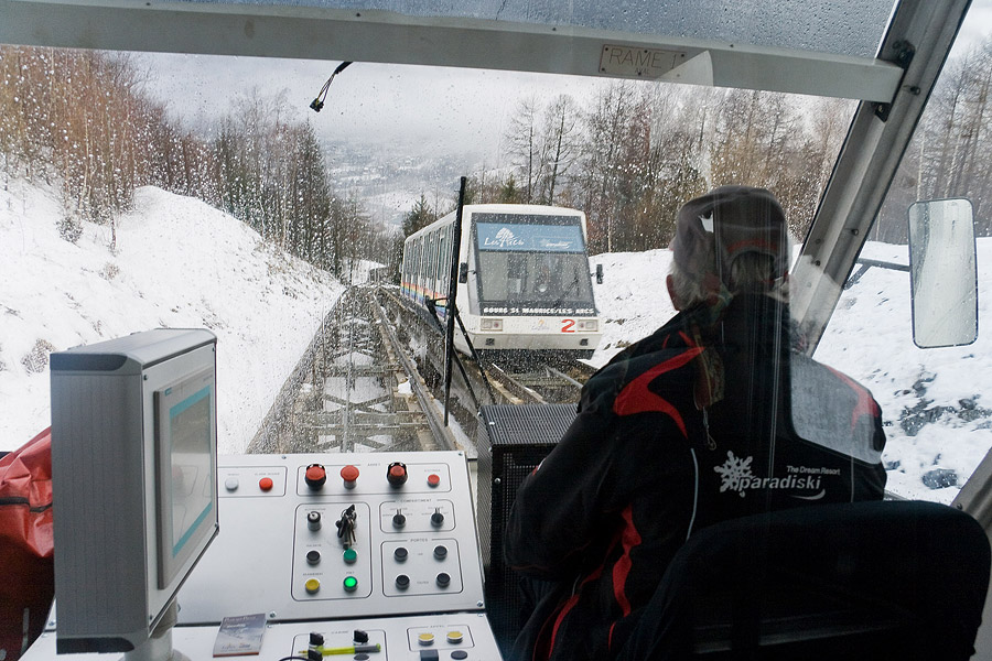 View from inside the Arc-en-Ciel funicular in winter as the descending car passes on the loop