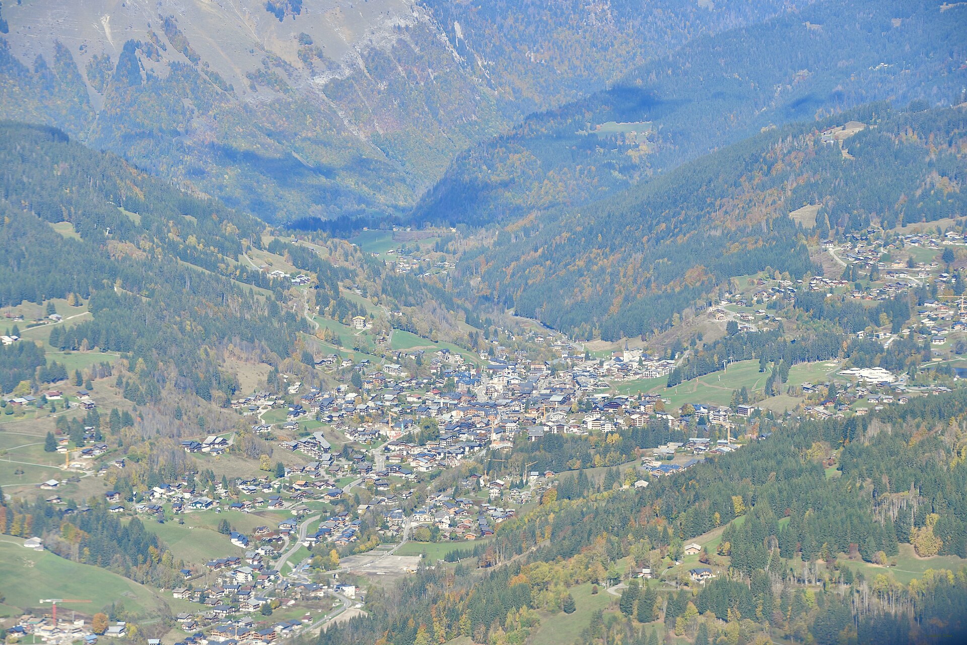Les Gets seen from the mountainside above, the village spread along its col between two wooded valleys