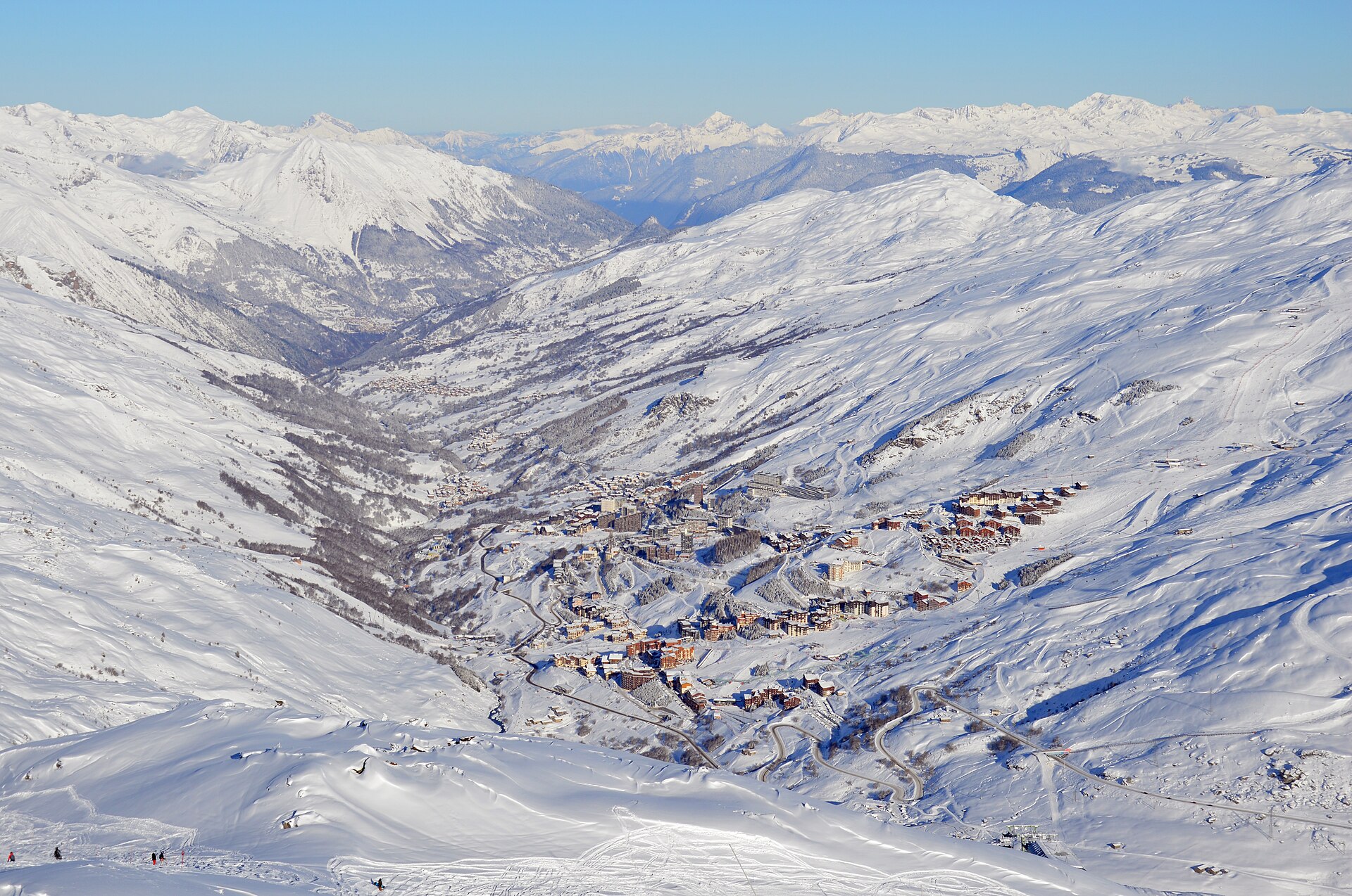 Les Menuires and the snow-covered Belleville valley seen from the pistes above, with the switchback access road visible