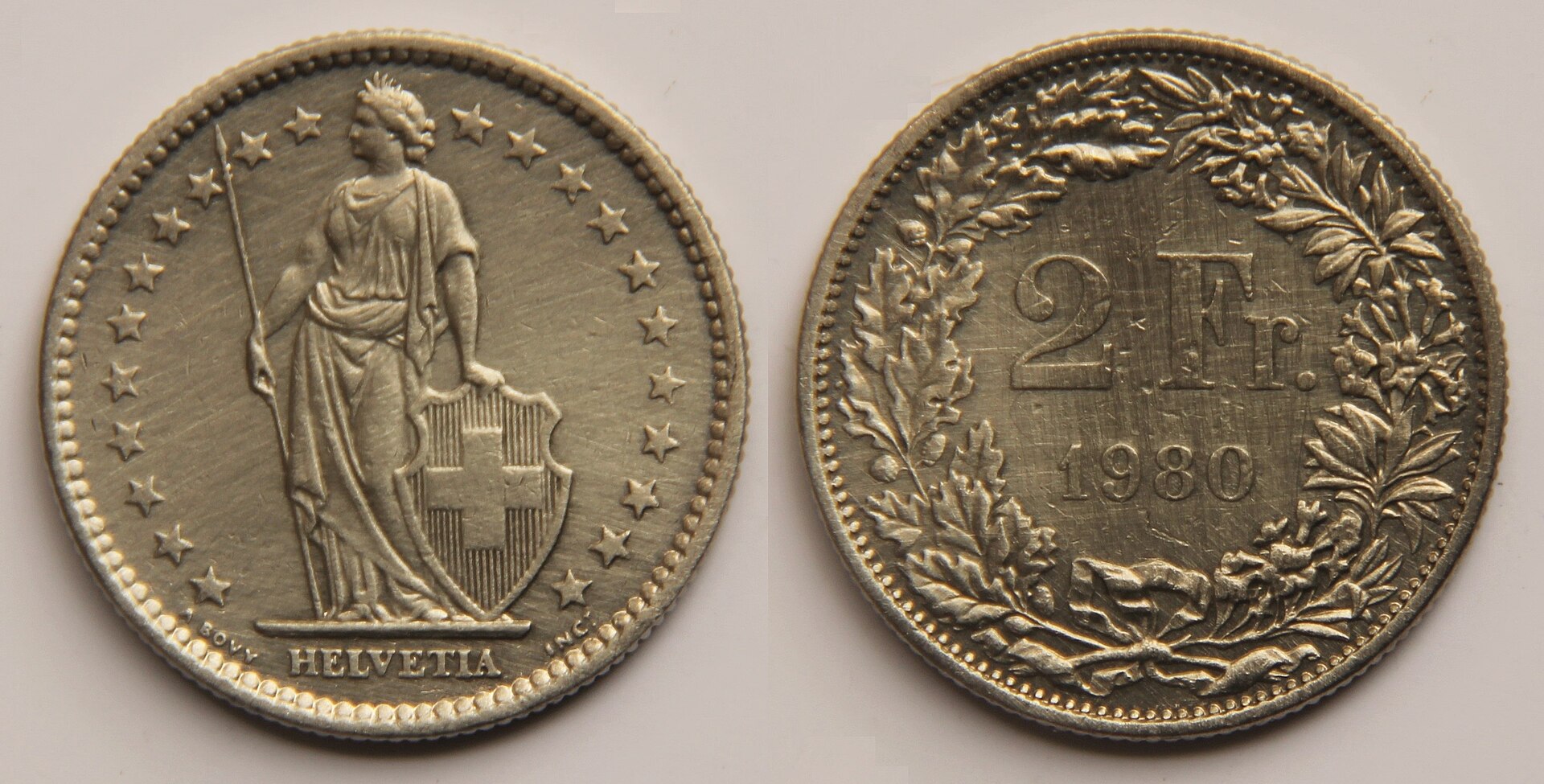 Both faces of a Swiss two-franc coin show standing Helvetia and the denomination above a wreath and the date 1980.