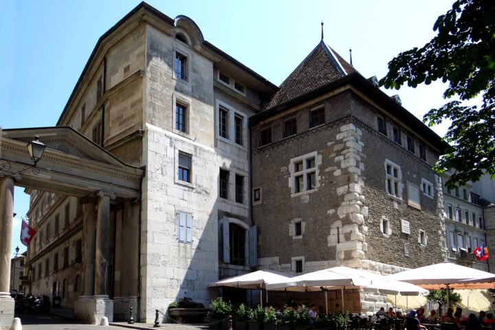 Café Papon's parasol-covered terrace sits beneath the stone Tour Baudet beside Geneva's City Hall.
