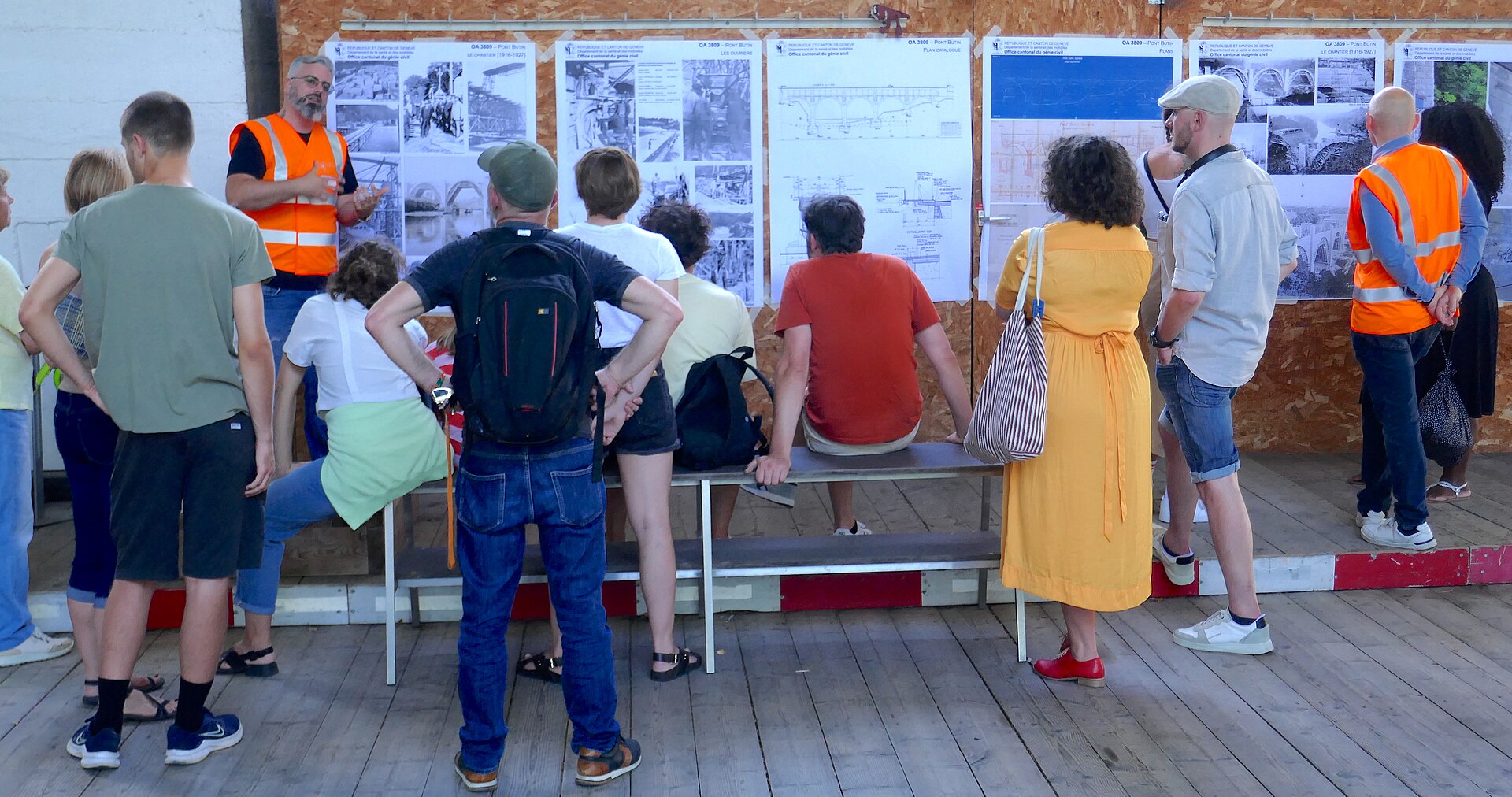 Visitors reading information panels on a wooden walkway inside the structure of the Pont Butin in Geneva during the 2024 European Heritage Days