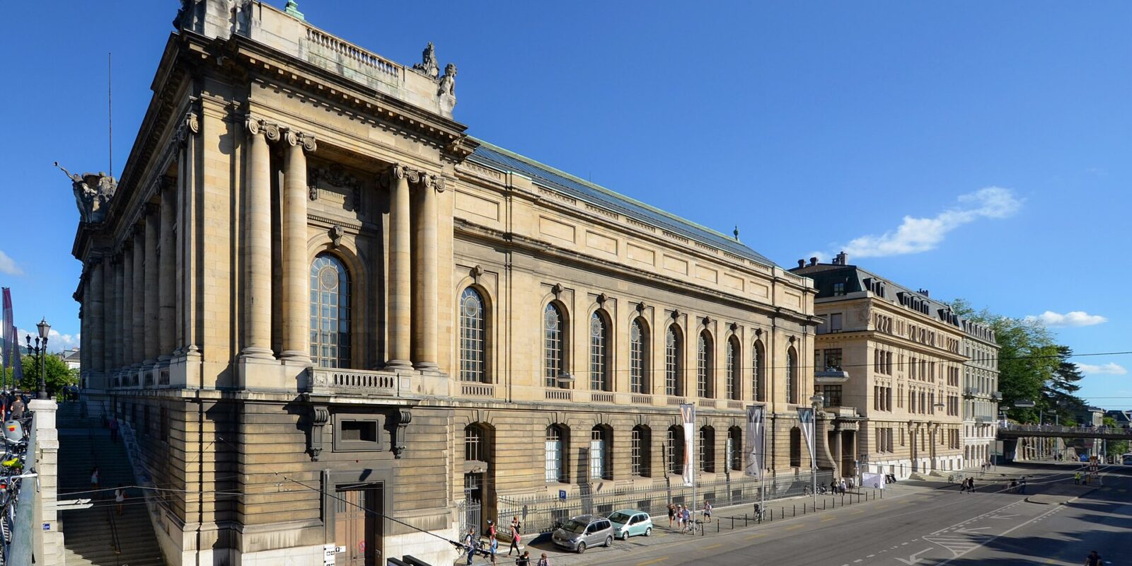 Geneva’s Museum of Art and History rises above the street, with monumental columns, arched windows and sculptures along the roof.