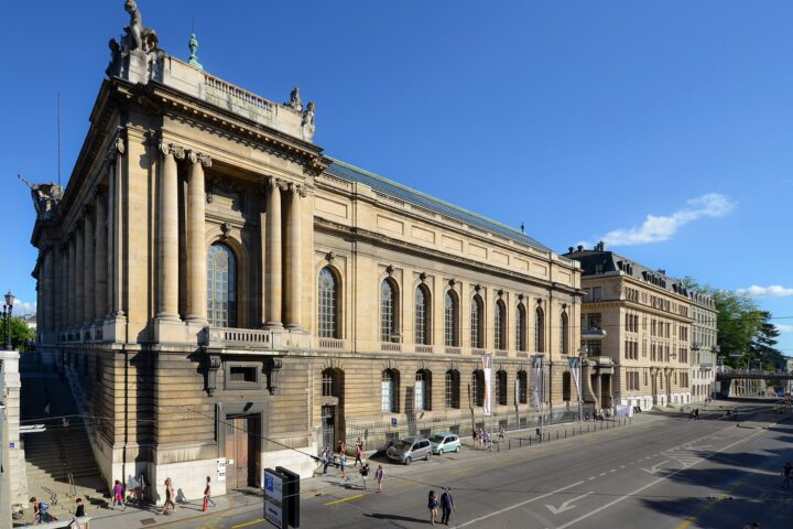 Geneva’s Museum of Art and History rises above the street, with monumental columns, arched windows and sculptures along the roof.