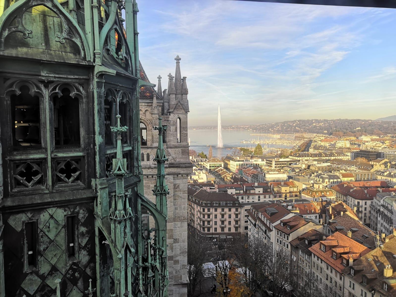 The view from the top of St Pierre Cathedral over the spires and the rooftops of Geneva's Old Town to the Jet d'Eau and the lake