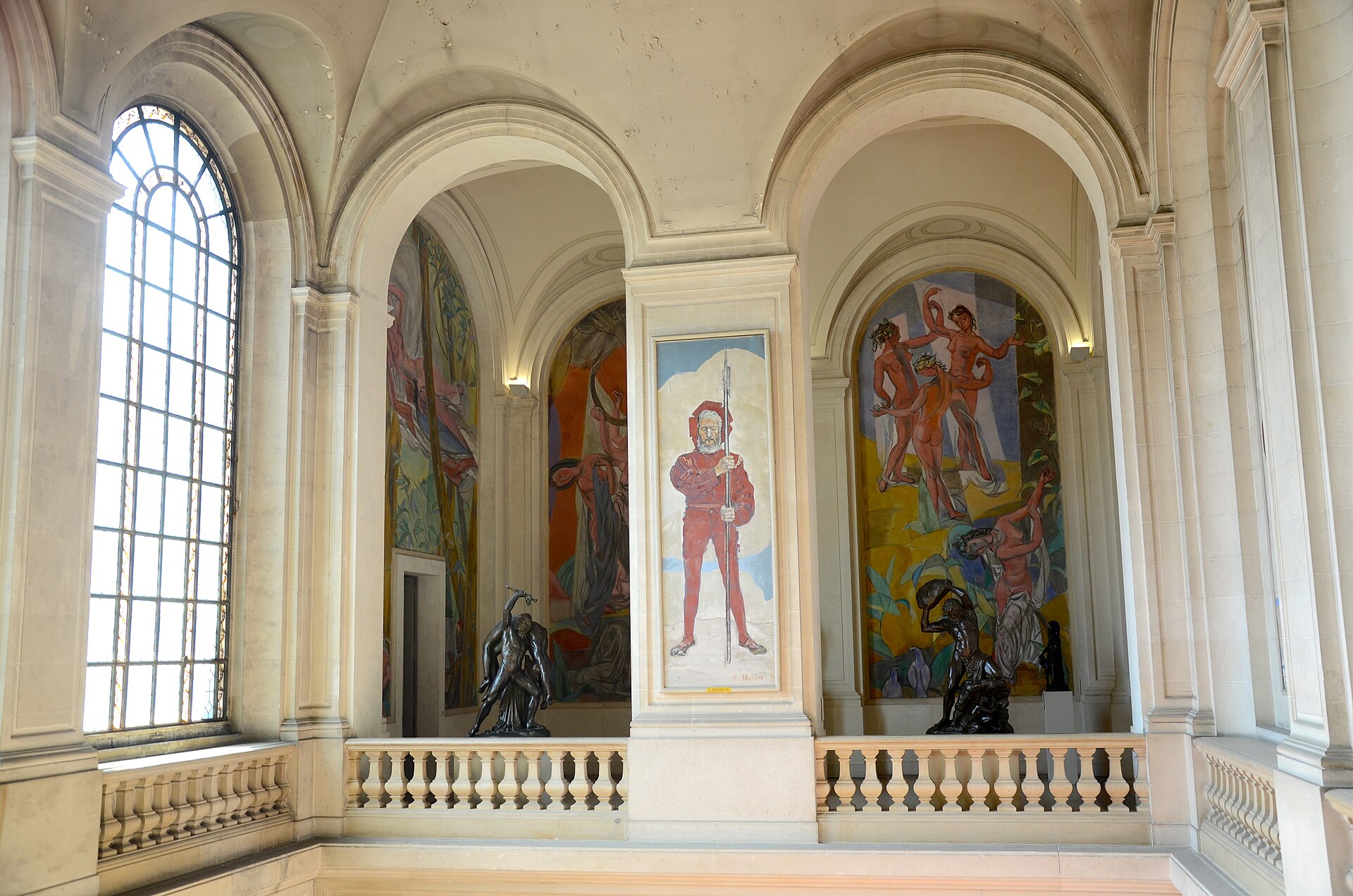 Large figurative paintings and dark sculptures line a vaulted, sunlit hall inside Geneva’s Museum of Art and History.