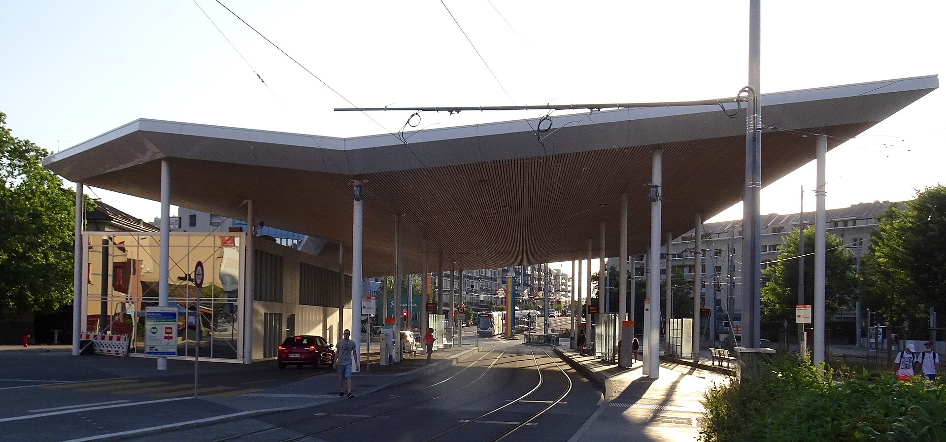 The Moillesulaz customs post between Geneva and France, with tram tracks and a road passing beneath its broad canopy.