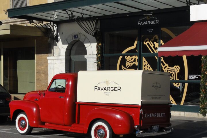 A red Favarger delivery truck stands outside the chocolatier's signed boutique on Quai des Bergues in Geneva.