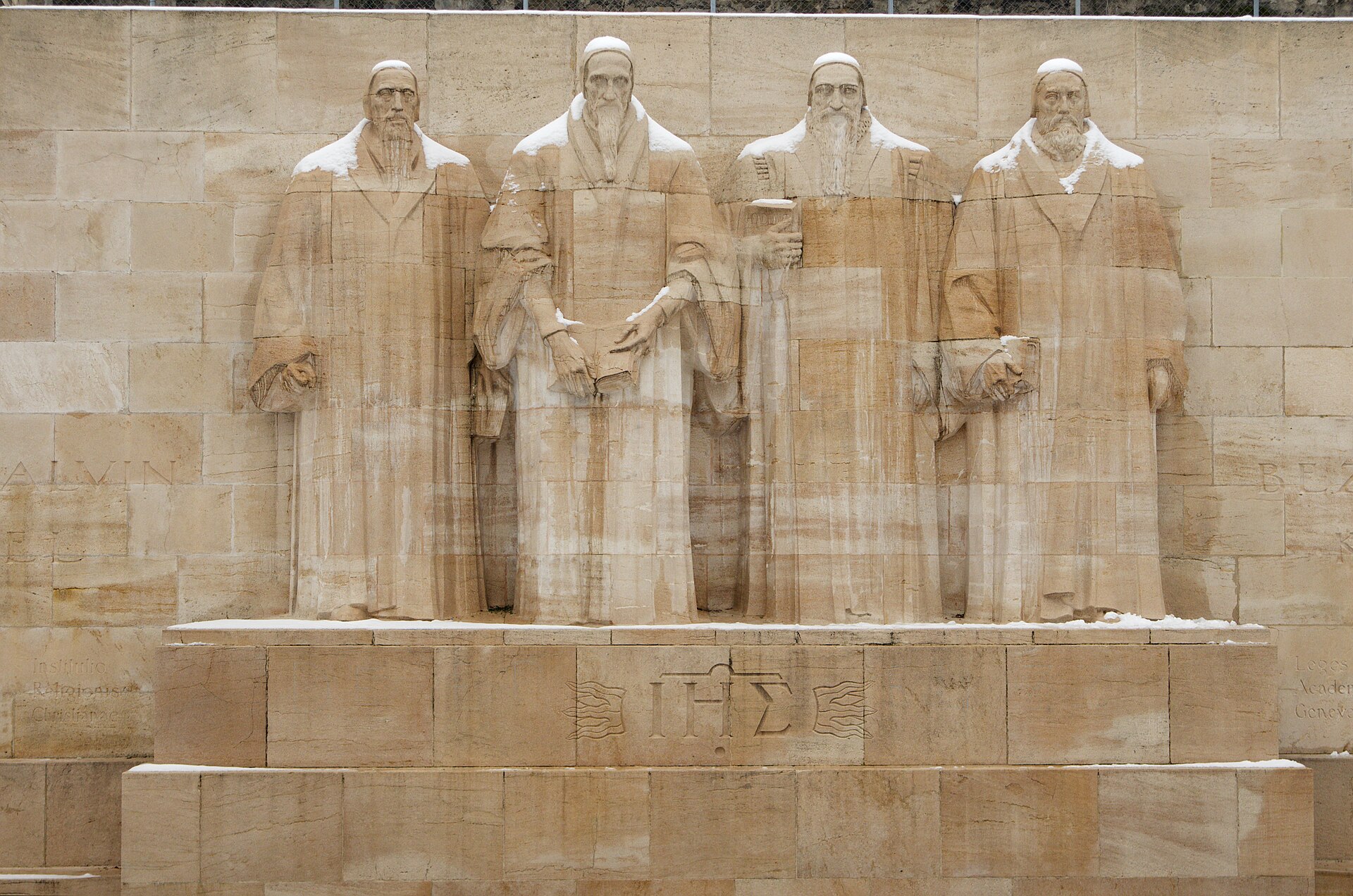 Snow rests on the shoulders of Farel, Calvin, Beza and Knox at the Reformation Wall in Geneva.