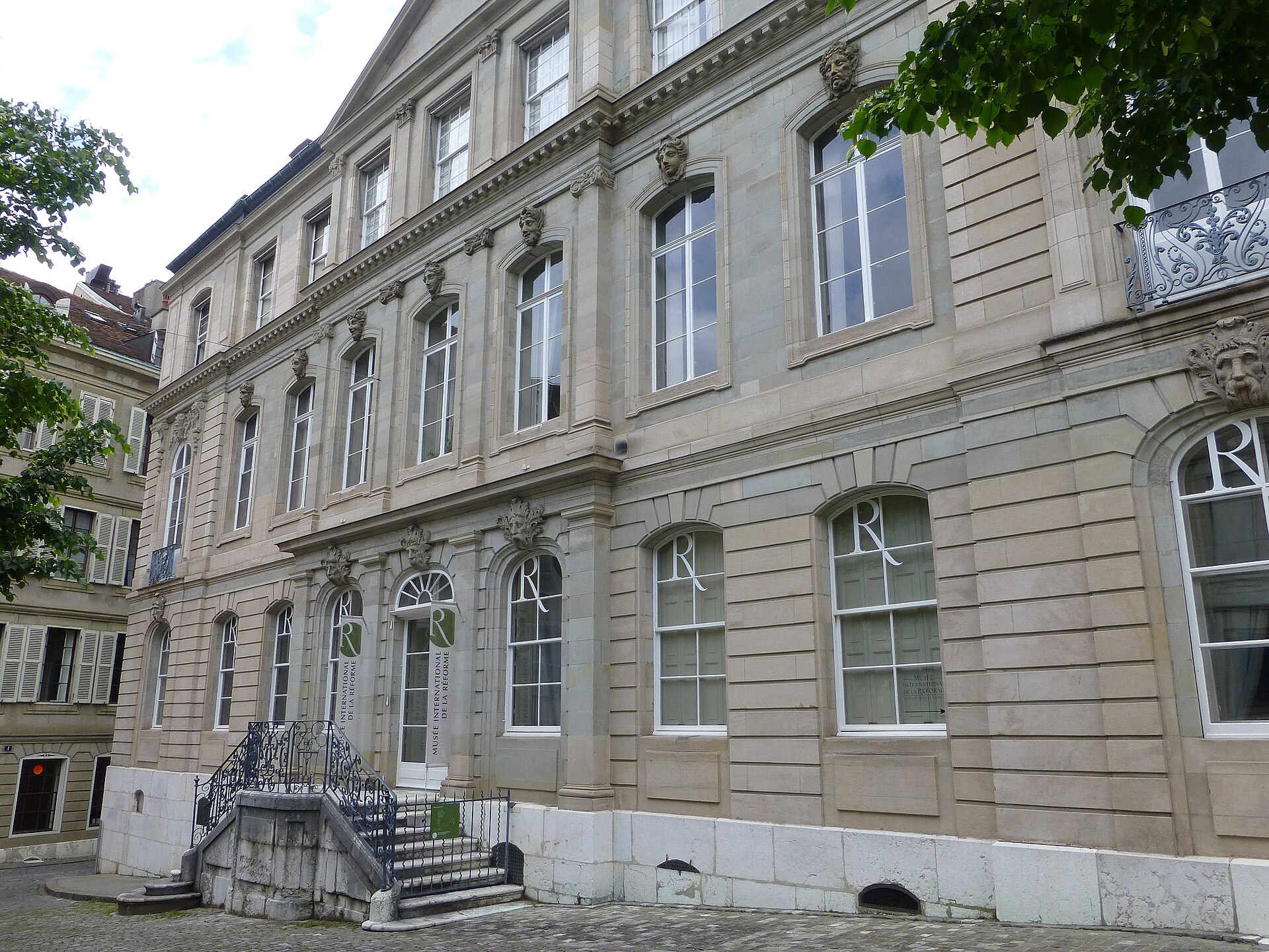 The pale stone eighteenth-century facade of the Maison Mallet, home of the International Museum of the Reformation, on the Cour de Saint-Pierre in Geneva